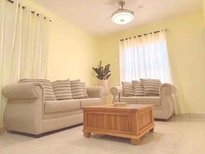 a living room with two couches and a coffee table at Our Cozy Home, Wi-Fi, AC, Parking, Near Beaches and Attractions in quiet area in Nagua