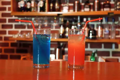 two cocktails sitting on a table in a bar at Hotel Merey in Santo Domingo