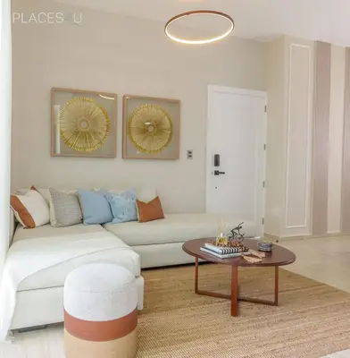 a living room with a white couch and a table at Cerca de la playa y restaurantes espacio relajante in Punta Cana