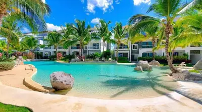 a swimming pool with palm trees in front of a building at Luxury Apartment Dominicus in La Laguna
