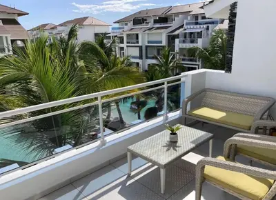 a balcony with chairs and a table and a swimming pool at Luxury Apartment Dominicus in La Laguna