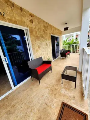 a living room with a couch and a table at Bella Villa Roomy apartment at 5 min walk to the beach in Las Galeras