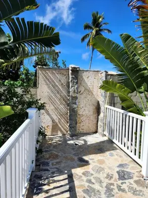 a stairway with a white fence and a palm tree at Bella Villa Roomy apartment at 5 min walk to the beach in Las Galeras