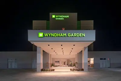 a building with a sign that reads w withdrawal garden garden at Wyndham Garden El Morro Montecristi in El Rincón