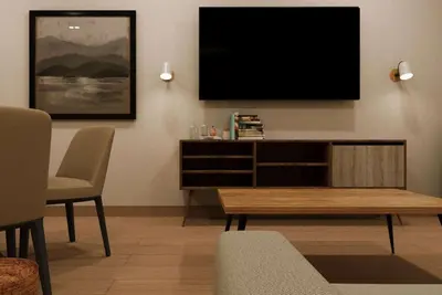 a living room with a flat screen tv on a wall at Wyndham Garden El Morro Montecristi in El Rincón