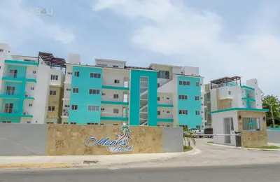 a large apartment building with blue and white at Hermoso apartamento 1 hab a pasos de la playa in Punta Cana