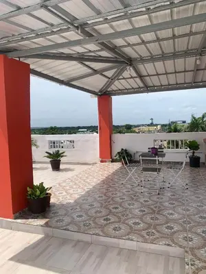 a patio with a table and chairs on a roof at Plataview Apartahotel 3B in Monte Plata