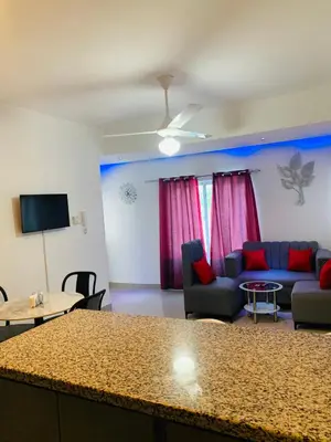 a living room with a couch and a table at Plataview Apartahotel 3B in Monte Plata