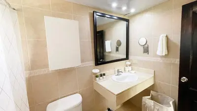 a bathroom with a sink and a toilet and a mirror at Cozy apartment Golf Course View in Punta Cana in Punta Cana