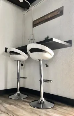 two white bar stools sitting in a room at MOKA HOUSE in Santo Domingo