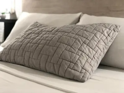 a close up of a bed with a quilt at MOKA HOUSE in Santo Domingo