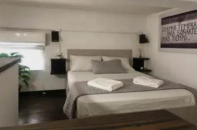 a bedroom with a bed with two towels on it at MOKA HOUSE in Santo Domingo
