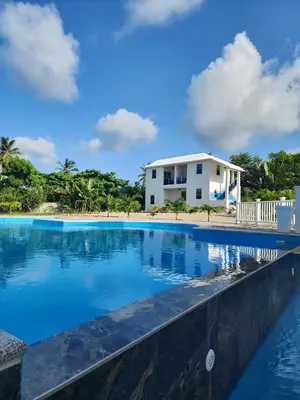 a swimming pool with a house in the background at Bella Villa room with large pool and close to beach in Las Galeras