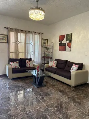 a living room with two couches and a table at Casa Jacaranda -10 pax, Cerca de la Playa in Las Galeras