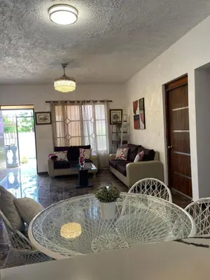 a living room with a glass table and chairs at Casa Jacaranda -10 pax, Cerca de la Playa in Las Galeras