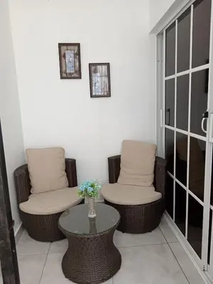 a room with two wicker chairs and a table at APARTAMENTOS DE 1 2 Y 3 HABITACIONEs in Santiago de los Caballeros