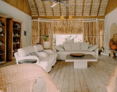 a living room with a couch and a table at Buena Vida Macao 7 habitaciones in Salado