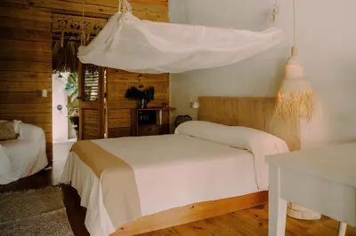 a bedroom with a white bed with a canopy at Buena Vida Macao 7 habitaciones in Salado
