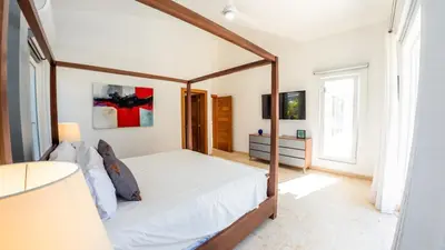 a bedroom with a bed with a wooden frame at Villa Collie Luxury Retreat7 King Master BRMaid in Sosúa