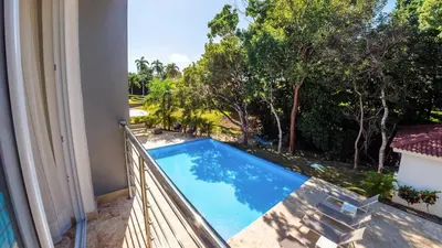 a view of a swimming pool from the balcony of a house at Villa Collie Luxury Retreat7 King Master BRMaid in Sosúa