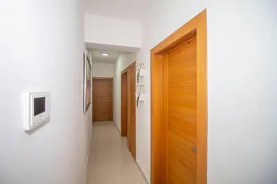 a hallway with a door and a television on a wall at Brand New Luxury Home in Santo Domingo