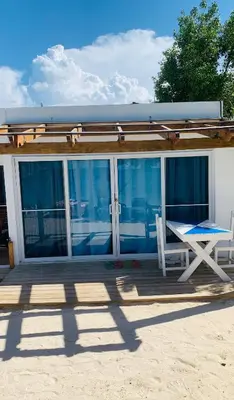 a deck with a table and a chair on a house at La Isla Bonita in Punta Rucia