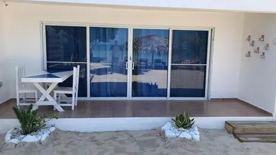 a room with a desk and a table and windows at La Isla Bonita in Punta Rucia