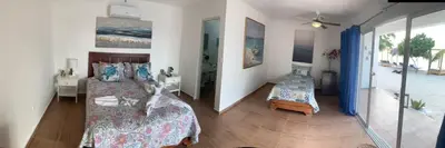 a bedroom with two beds and a balcony at La Isla Bonita in Punta Rucia
