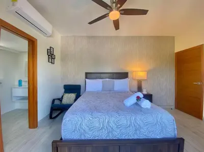 a bedroom with a bed with a teddy bear on it at Cozy City Center Condo, Full AC in Los Prados