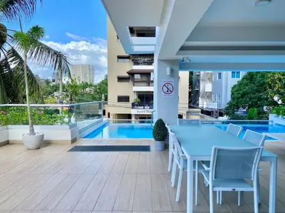 a patio with a table and chairs and a pool at Cozy City Center Condo, Full AC in Los Prados