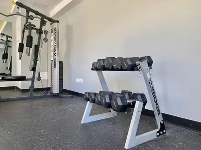 a gym with a squat rack in a room at Cozy City Center Condo, Full AC in Los Prados