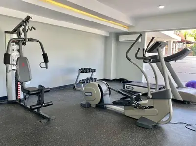 a gym with two tread machines and a treadmill at Cozy City Center Condo, Full AC in Los Prados