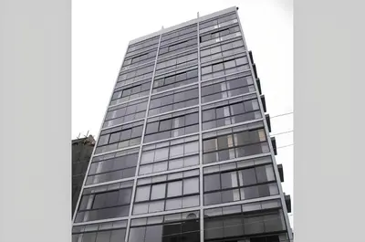 a tall glass building with a lot of windows at New Loft Apt Full AC King Bed in Santo Domingo
