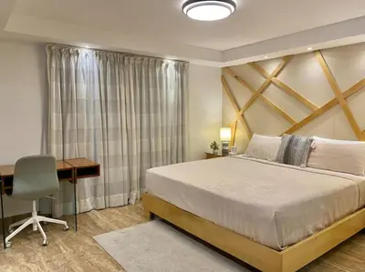 a bedroom with a large bed and a desk and a desk at Lovely Sto Dgo Center Apt in Santo Domingo