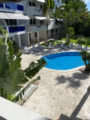 an empty swimming pool in front of a building at New Garden Hotel in Sosúa
