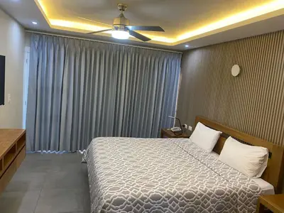 a bedroom with a bed and a ceiling fan at New Garden Hotel in Sosúa