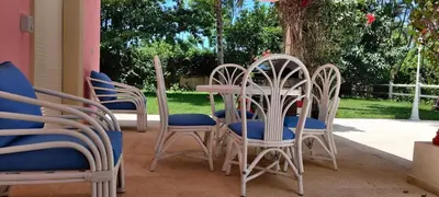 a group of chairs and a table on a patio at Casa angelina in Sosúa