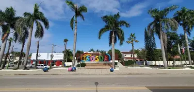 a park with a colorful monument with palm trees at Casa angelina in Sosúa
