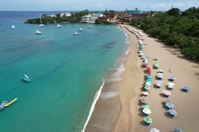 an aerial view of a beach with umbrellas and boats at Casa angelina in Sosúa