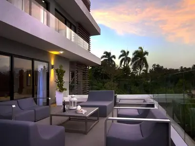 a patio with purple chairs and tables on a building at RIBERAMAR Las Terrenas, Samana in Las Terrenas