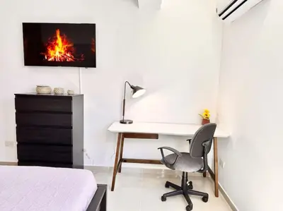 a bedroom with a desk and a bed and a desk with a chair at Beautiful Condo in Bella Vista in Los Prados