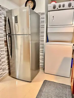 a kitchen with a stainless steel refrigerator and a stove at Beautiful Condo in Bella Vista in Los Prados