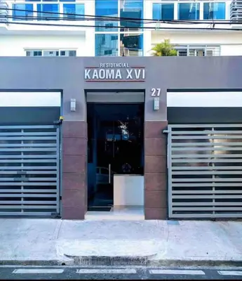 a building with two garage doors on a street at Beautiful Condo in Bella Vista in Los Prados