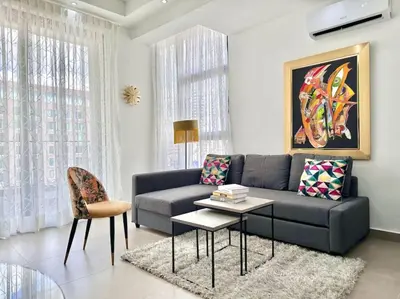 a living room with a couch and a table at Stunning City Center Condo in Los Prados