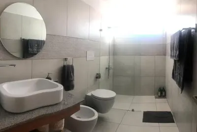 a bathroom with a sink and a toilet and a mirror at Estrella Dominicus con hermosa piscina! 1st floor in La Laguna
