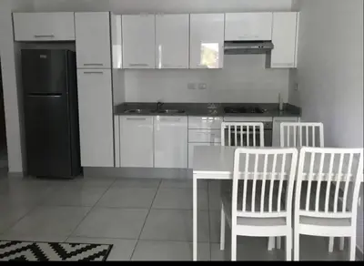 a kitchen with a table and chairs and a refrigerator at Estrella Dominicus con hermosa piscina! 1st floor in La Laguna