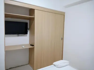a bathroom with a toilet and a tv in a room at Elegant and confortable close to Boca Chica Beach in Boca Chica