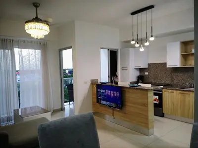 a kitchen with a counter with a tv in it at Elegant and confortable close to Boca Chica Beach in Boca Chica