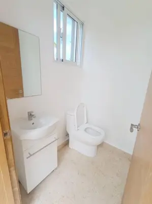 a bathroom with a toilet and a sink and a mirror at Private Villa 4 BR at Playa Bonita, Las Terrenas in Las Terrenas