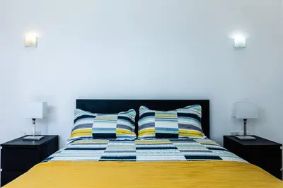 a bedroom with a yellow bed with two night stands at Private Villa 4 BR at Playa Bonita, Las Terrenas in Las Terrenas